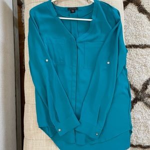 Turquoise colored blouse perfect for professional work attire.